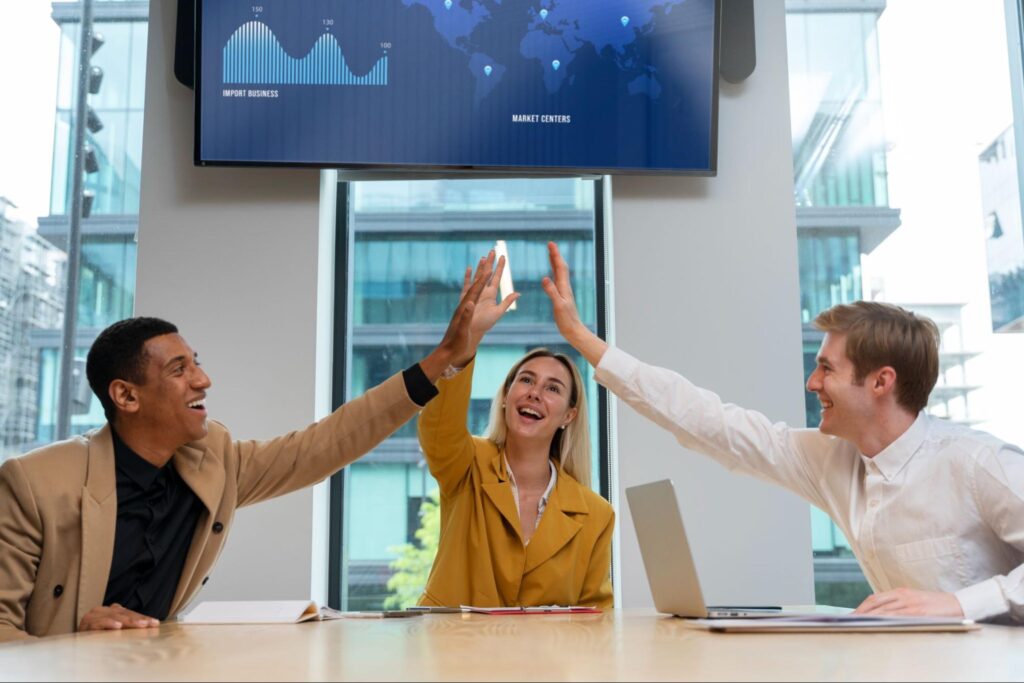 Google Ads Malaysia agency team celebrating campaign success with strong ROI and client growth.